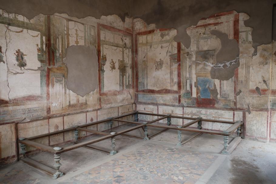 Die Liegen, auf denen früher stundenlang diniert wurde, wurden rekonstruiert. Nur die bronzenen Beine haben die Hitze der Asche überstanden.